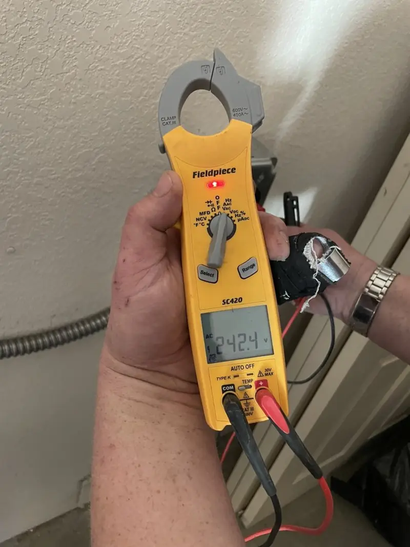Voltage testing with clamp meter during Whole House Surge Protector in Morris